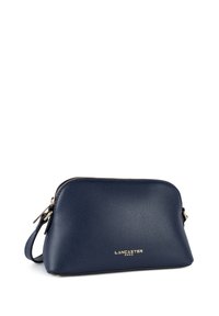 Borsa a mano in pelle blu navy con finitura testurizzata, zip dorata e logo, chiusura con zip e manico corto.