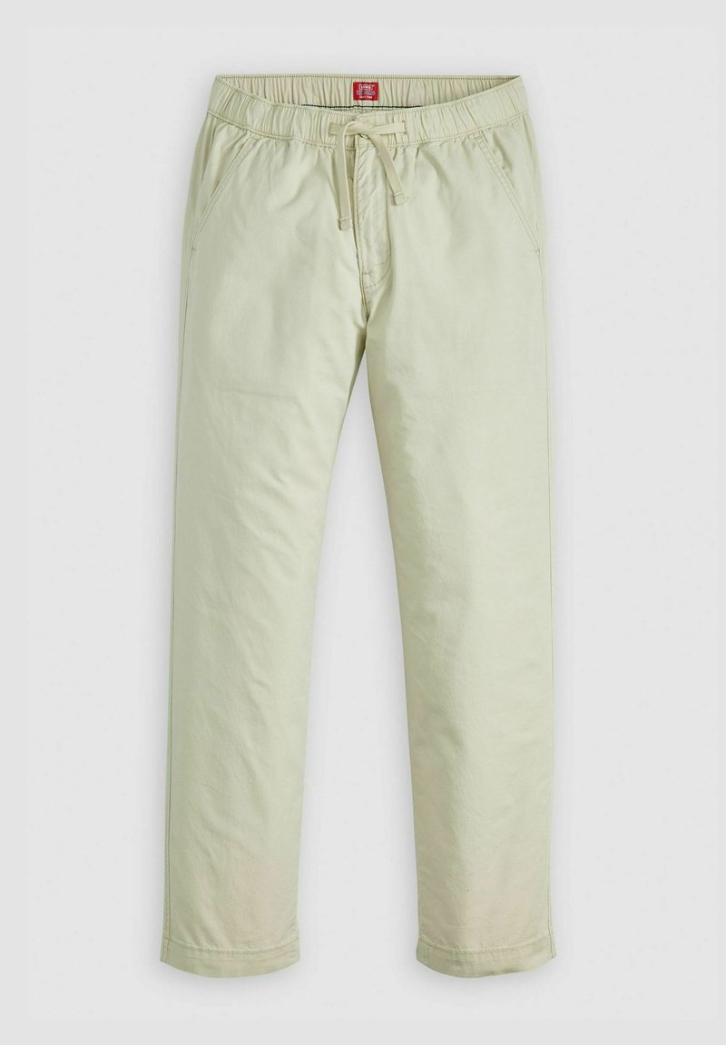Pantalones de algodón verde claro con cintura elástica y cordón ajustable. Presenta bolsillos laterales y un diseño de pierna ajustada. Textura suave.