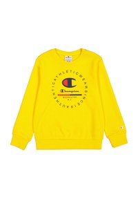 Sudadera amarilla con puños y dobladillo acanalados, con un gráfico de logo en rojo y azul en el centro frontal y un pequeño logo en la manga.