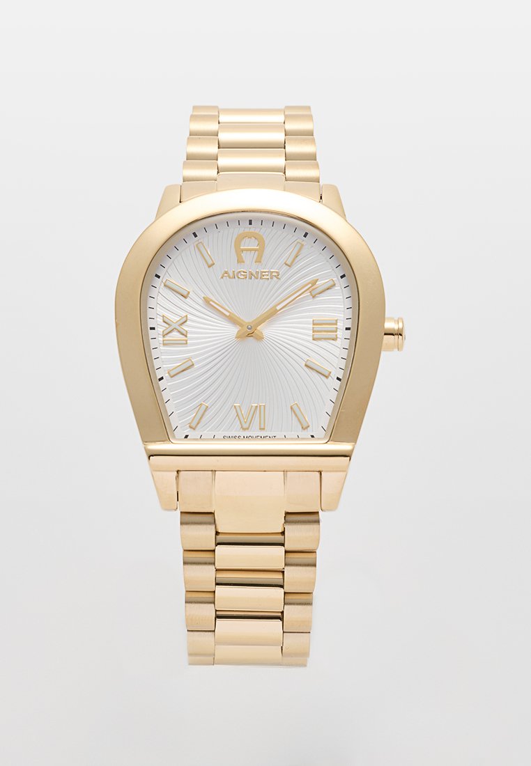 Goldfarbene Metallarmbanduhr mit einem einzigartigen ovalen Gehäuse, weißem strukturiertem Zifferblatt, goldenen arabischen Ziffern und einem verlinkten Armband. Auffälliges Logo bei 12 Uhr.