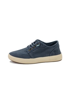 Canvas sneakers in navy blue with a light beige rubber sole, featuring six eyelets and turquoise lace accents, smooth texture.