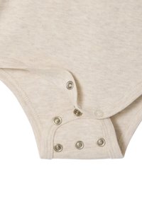 Cream-colored cotton bodysuit with a soft texture, featuring snap closures at the bottom and rounded edges.