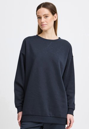 Navy pullover sweatshirt with a relaxed fit, crew neckline, and ribbed cuffs. Soft texture, simple design, and no embellishments.
