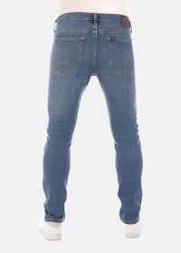 Dunne blauwe denim jeans met een vijf-pocket ontwerp. Voorzien van contrasterende stiksels en een leren label op de achterkant van de tailleband.