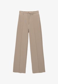 Beige leveled housut, jotka on valmistettu sileästä kankaasta. Niissä on tasaiset etuosat ja kaksi pystysaumaa jokaisessa jalassa. Ei näkyvää metalliosaa tai kuvioita.