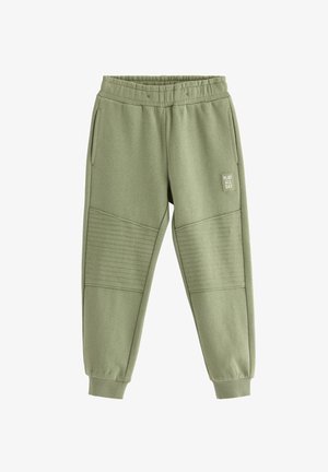 Pantaloni della tuta verde oliva con una fascia elastica in vita, due tasche laterali e pannelli testurizzati sulle ginocchia. Presenta un piccolo logo "PLAY ALL DAY".