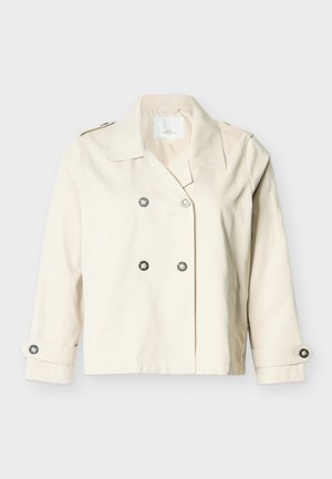Κρεμ διπλής σειράς κοντό σακάκι με φαρδιά γιακά, τέσσερα κουμπιά μπροστά και κουμπωτές λουρίδες στα μανίκια.