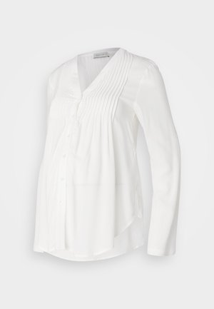 Weißes, knopfbares Umstandsblusenshirt mit langen Ärmeln, gefälteltem Vorderteil und geschwungenem Saum. Hergestellt aus leichtem, atmungsaktivem Material.