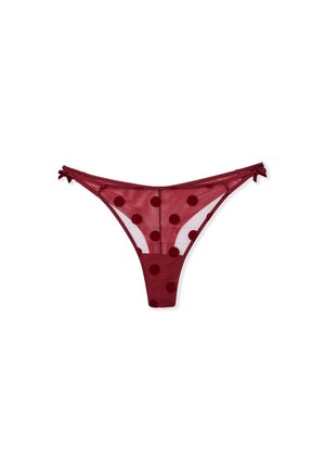 Bordeaux mesh string met grote stippen, dunne zijkanten en kleine strikjes op de heupen. Heeft een doorschijnende textuur en minimale bedekking.