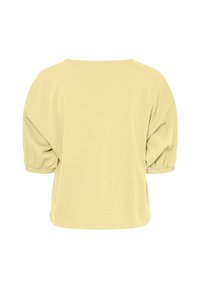 Top med puffärmar i mjukt gula tyg. Rund hals, avslappnad passform och gathered ärmar med elastiska manschetter, med en slät yta.