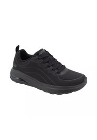 Scarpa da atletica nera con tomaia testurizzata, chiusura con lacci e suola imbottita. Presenta un'unità di ammortizzazione ad aria trasparente nel tallone.