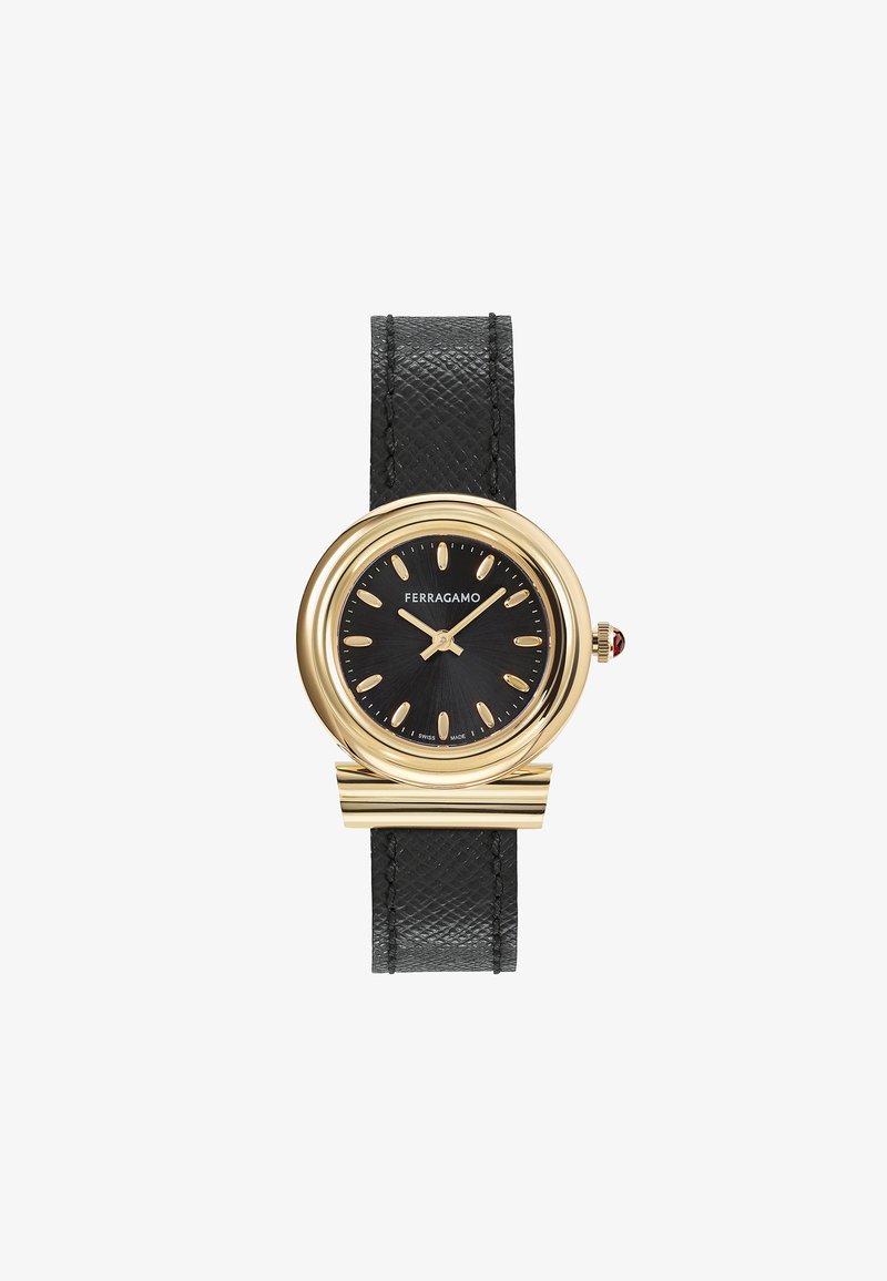 Reloj de pulsera dorado con correa de cuero negro texturizado, esfera redonda negra, marcadores de hora dorados y un acento rojo en la corona.