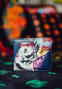 Wallet made of synthetic material features colorful graffiti art with a prominent sculpted head design on a dark blue background.