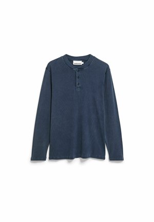 Langärmeliges Henley-Shirt in Dunkelblau. Hergestellt aus strukturiertem Stoff mit Vier-Knopfleiste sowie geripptem Kragen und Bündchen. Ohne Muster oder Verzierungen.