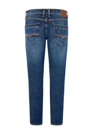 Blue denim jeans with a slim fit, featuring two back pockets and a contrast stitching. The waistband includes a tan leather patch.