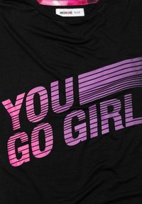 Black shirt with "YOU GO GIRL" in pink and purple gradient horizontal stripes, and a pink collar trim with a Minoti brand label.
