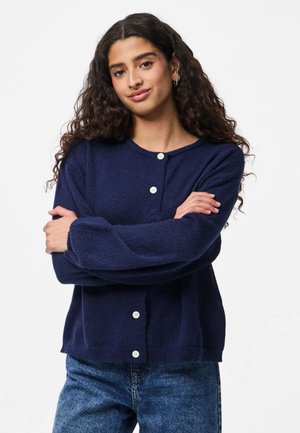Navy knitted cardigan with long sleeves, round neckline, and five white buttons down the front. Casual fit and textured fabric.