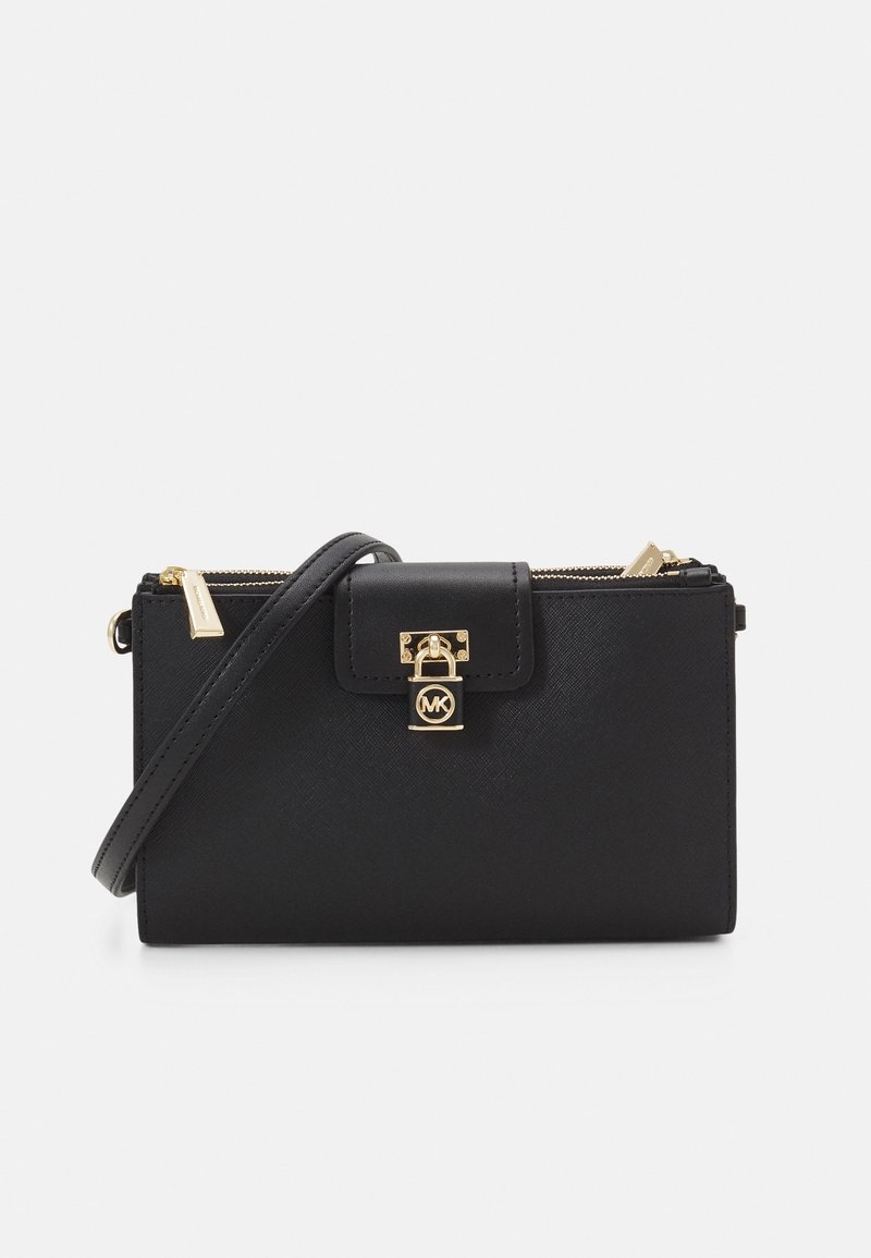 Black leather crossbody bag with a gold lock closure, zip pocket, and adjustable strap. Textured finish and MK logo accent on front.