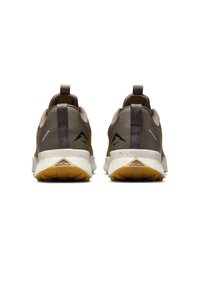 Brown and beige athletic shoes with a textured upper, featuring a grey pull tab, white speckled midsole, and orange outsole with treads.