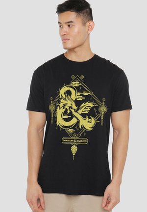 Black cotton t-shirt featuring yellow Dungeons & Dragons graphic with dragon design, geometric shapes, and text at the bottom.