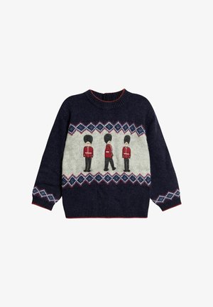 Marineblauer Strickpullover mit rot-, blau- und weißen geometrischen Mustern und drei gestickten Wachen in roten Uniformen und hohen schwarzen Hüten über der Brust.