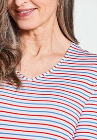 Baumwoll-T-Shirt mit V-Ausschnitt, versehen mit horizontalen roten und blauen Streifen auf einem weißen Hintergrund. Glatte Textur, lässiges Design.