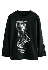 Maglietta nera a maniche lunghe con personaggio pixelato di Minecraft e il testo "Crafting Since Alpha" e il logo "Minecraft" sul davanti.