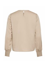 Beige langermet bluse med en glatt tekstur, nøkkelhull-design bak og innsamlede mansjetter. Enkel, minimalistisk silhuett.