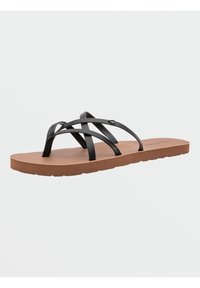 Sort flip-flop med krydsede stropper og en brun struktureret sål. Har et fladt design og minimal hardware-detaljering.