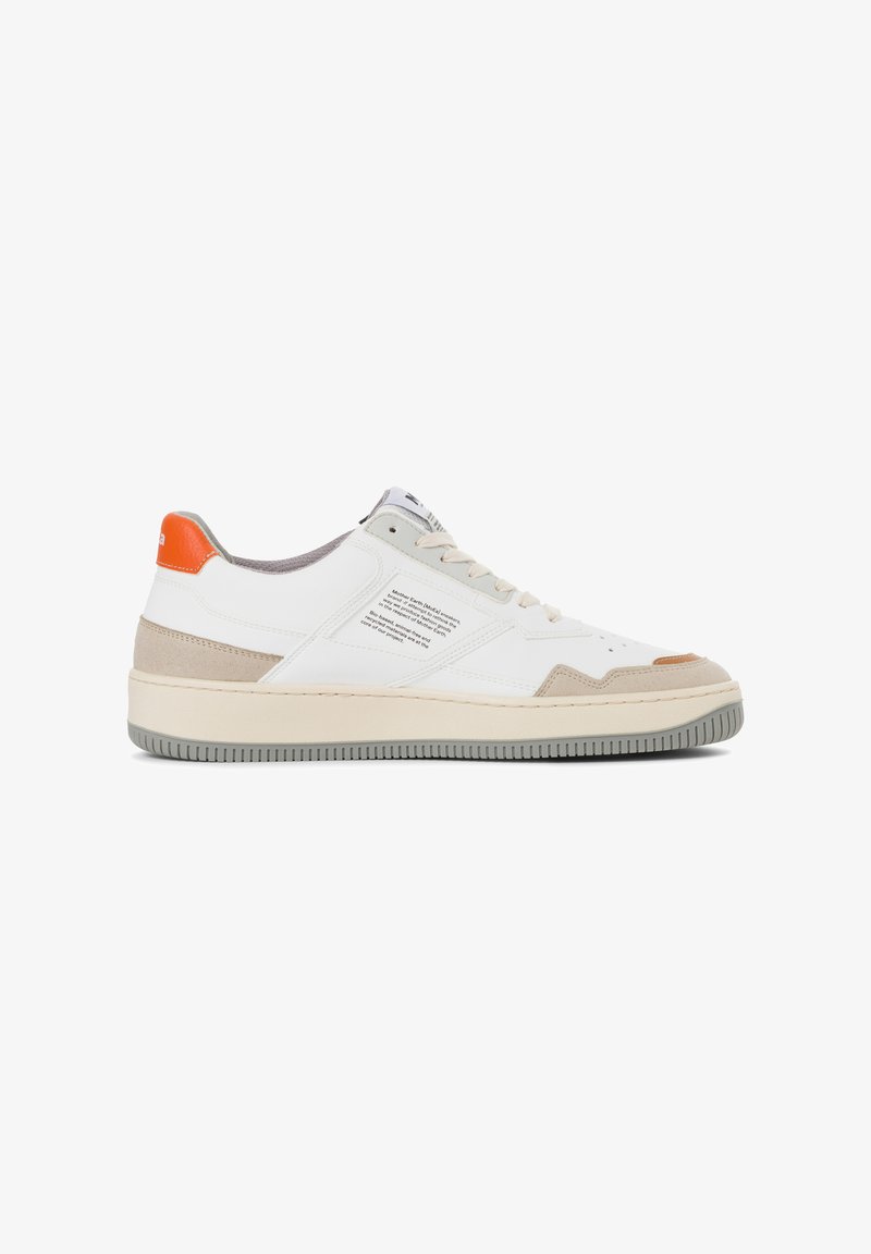 White sneaker with a textured beige suede accent, orange heel, and grey rubber sole. Features a printed label on the side.