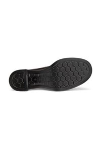 Sole of a shoe featuring a honeycomb tread pattern. The design indicates durability and grip, with a logo embossed near the heel.
