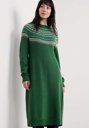 Green knitted dress with long sleeves, featuring a patterned yoke in cream, blue, and brown. Smooth texture, relaxed fit, hem below the knee.