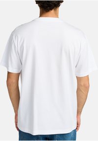 White cotton t-shirt with a relaxed fit, round neckline, and short sleeves, featuring a plain back and no graphics or embellishments.