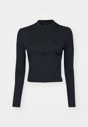 Top corto maniche lunghe nero in un tessuto liscio ed elastico, con colletto alto e zip sul retro. Presenta dettagli delle cuciture lungo le maniche.