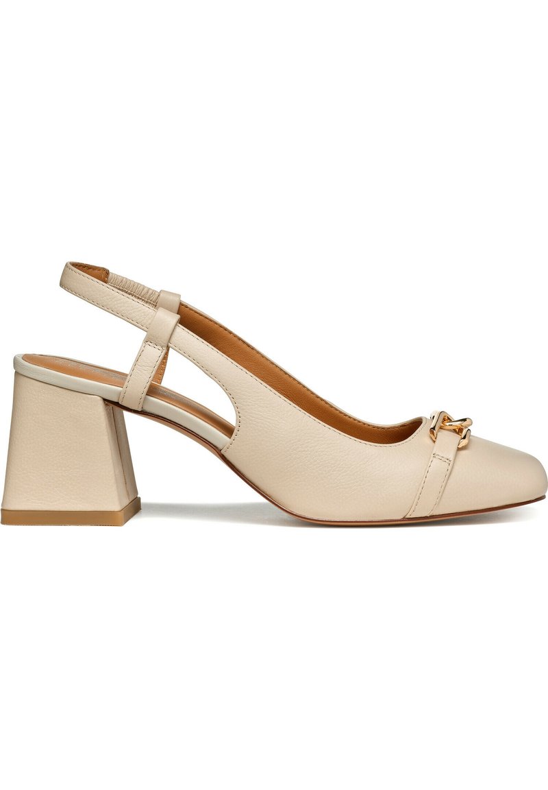 Pompe à talon bloc en cuir beige avec bride au talon, détail de chaîne dorée sur le bout et semelle intérieure rembourrée pour le confort.