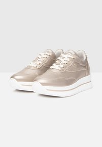 Metallic gold sneakers with a textured finish, white laces, and cushioned white sole. Features subtle side accents and padded collar.