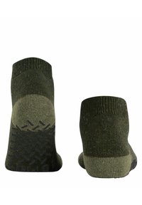 Grüne, strukturierte Socken mit einem gemusterten Strickdesign. Verfügt über eine kontrastierende, dunkler grüne Gummisohle für rutschfesten Halt und Strapazierfähigkeit. Knöchelhoch.