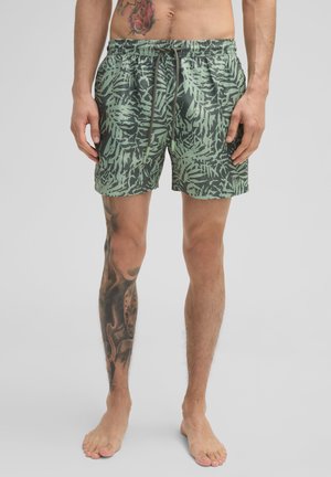 Groene zwemshorts met een bladerenpatroon, elastische tailleband en trekkoord. Gemaakt van lichtgewicht materiaal, heeft een relaxte pasvorm en is boven de knie.