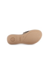 Suola della scarpa con una superficie in gomma beige testurizzata, caratterizzata da un accento rotondo e dal logo del marchio. Bordo liscio e forma sagomata.