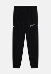 Black athletic pants with elastic waistband, tapered legs, side pockets, and white Nike swoosh logo; made of smooth, lightweight fabric.