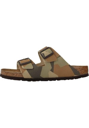 Camo-patterned slide sandal featuring two adjustable straps, made of synthetic material, with a cork footbed and a textured rubber sole.