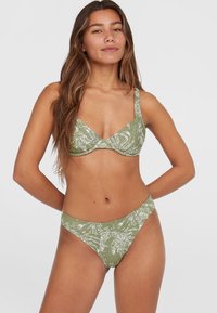 Zelené bikiny s listovým bielym vzorom. Vrchná časť má štruktúrovaný dizajn s nastaviteľnými ramienkami a spodná časť má klasický strih.