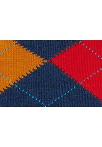 Multicolored fabric featuring an argyle pattern with diamonds in orange, red, and blue, stitched on a dark blue background with turquoise accents.