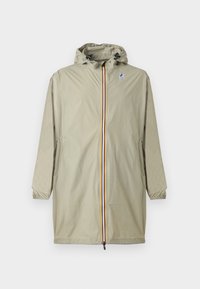 Ανοιχτό μπεζ αδιάβροχο με κουκούλα και μπροστινό φερμουάρ με μπλε, κίτρινες και κόκκινες ρίγες, ελαστικές μανσέτες και το λογότυπο K-Way στο στήθος.