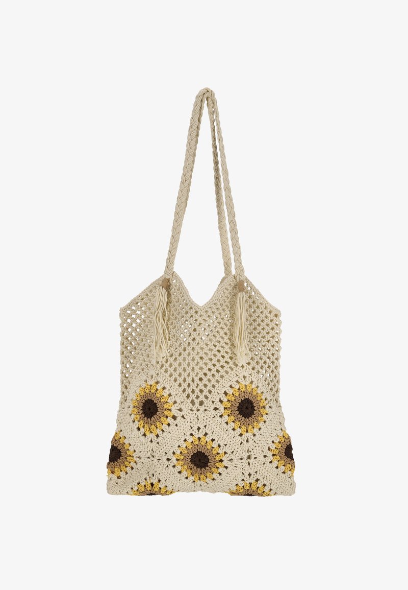 Krém színű horgolt táska sárga és barna napraforgó mintákkal. Fonott fogantyúkkal és bojttal, nyitott szövésű mintázattal.