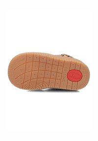 Semelle de chaussure en matériau caoutchouteux, avec une couleur beige texturée et un accent circulaire rouge près du talon. Motif en grille avec des étoiles.