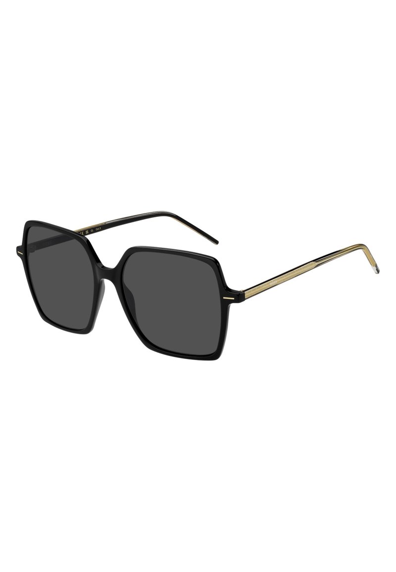 Mustat yliuurteiset neliösunglassit harmailla linsseillä. Niissä on kiiltävä muovikehys ja ohuet metalliset kultaiset yksityiskohdat temppeleissä.
