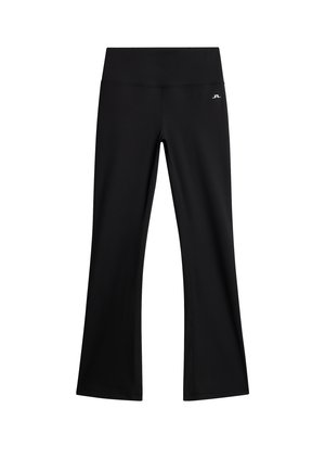 Leggings neri a vita alta, a gamba svasata, con cuciture minime e un piccolo logo bianco sulla coscia sinistra superiore.