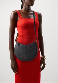 Coccinelle SUNUP - Käekott - noir/cuir
