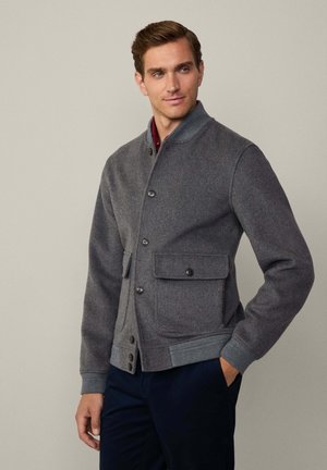 Gray wool blend bomber jacket with button closure, ribbed cuffs, and two front pockets, featuring a stand-up collar and smooth texture.
